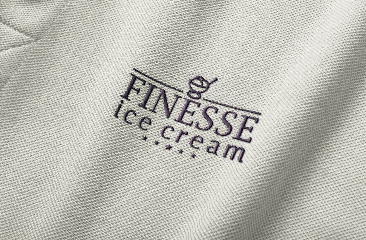 The Finesse mark embroidered into a staff polo shirt