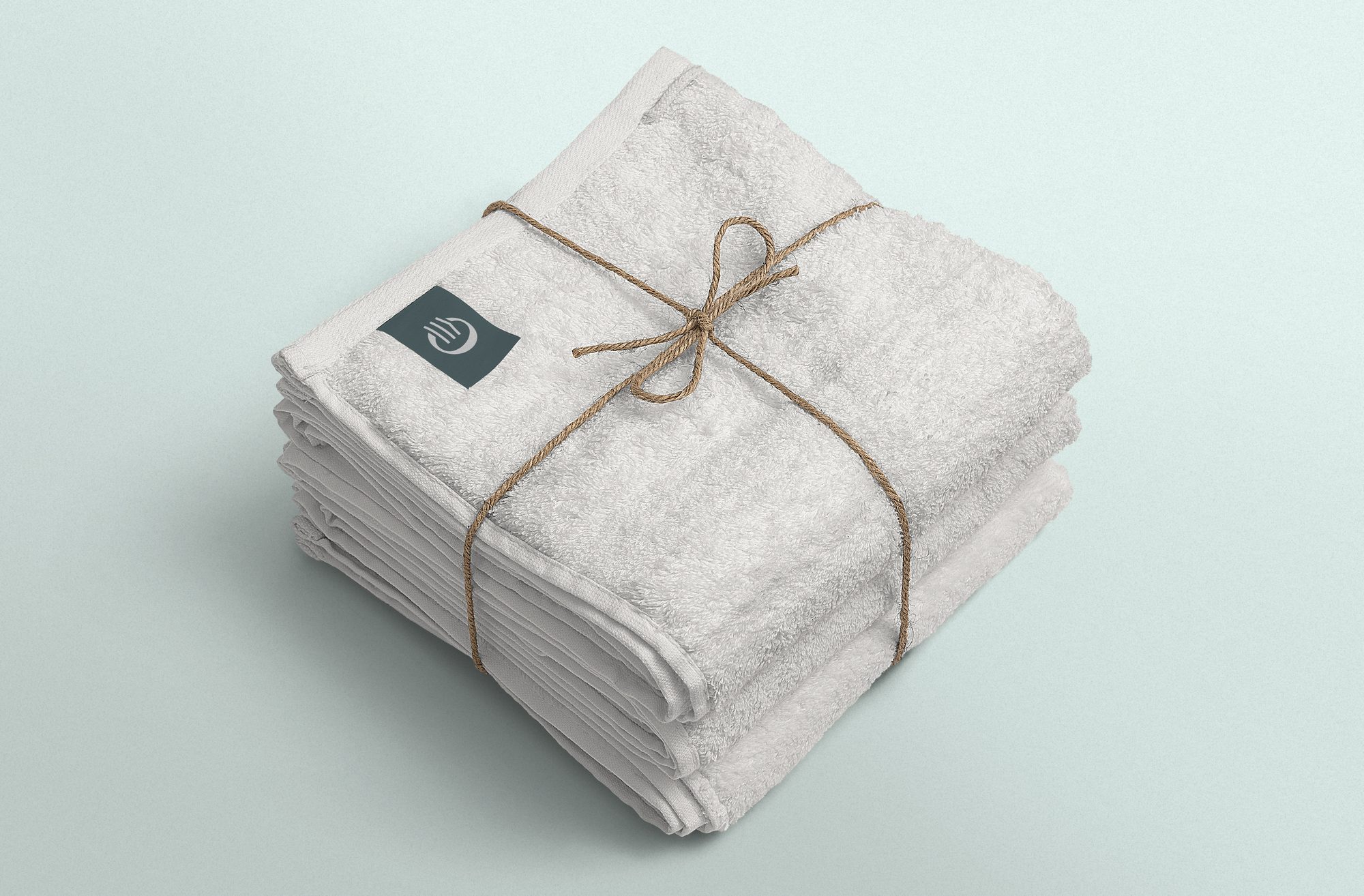 Folded Panoramic guest towels tied with twine and a branded label